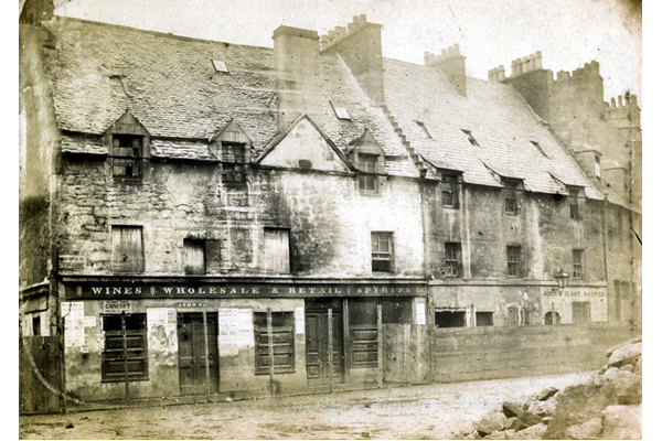 This view shows shops and houses in bad repair at the corner of Vennel and Dalrymple Street on the north side of Wallace Square, Greenock. - Photographed by Robert Urie - Bromide print on paper - P4211 - © McLean Museum and Art Gallery, Greenock