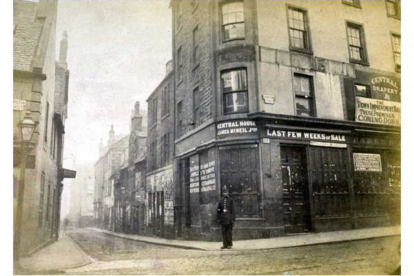 This view of the area was taken just prior to demolition. As one of the notices on the buildings states: 'The Town Improvement Bill - These premises coming down'. - Bromide print on paper - P4218 - © McLean Museum and Art Gallery, Greenock