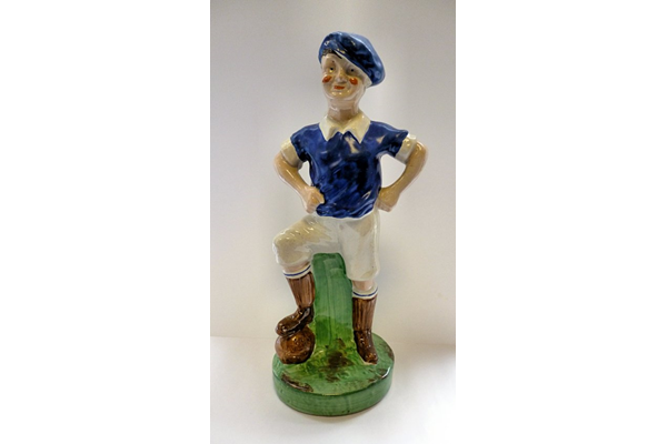 Ceramic footballer figurine. The figure was probably intended to be a Glasgow Rangers FC player with other versions of the same figure are known to have been painted in Celtic FC colours. - Late 19th/early century - 2006.193 - © McLean Museum and Art Gallery, Greenock.