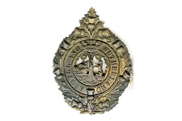 Cap badge of the Argyle & Sutherland Highlanders, the design was used from 1900 until 1959, but this example, according to the old label, is from the 2nd Battle of Ypres in  1915. - 1999.63.147 - © McLean Museum and Art Gallery, Greenock