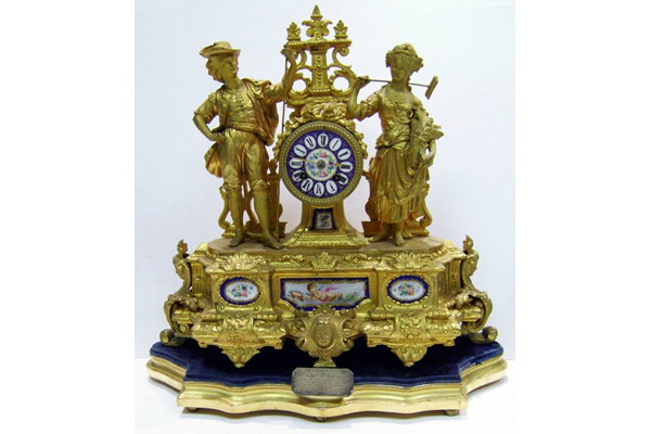 19th century gold painted cast iron presentation clock. The is inscribed: 'Presented to Mr. Thomas D. Rorison (along with a gem ring to Mrs Rorison) by the employees of Messrs. Crawhall Allison & Co. Sugar Refinery as a token of esteem, on the occasion of his leaving the works to occupy a better position. Greenock 14th July 1877'.  - 1998.11 ©McLean Museum and Art Gallery, Greenock.