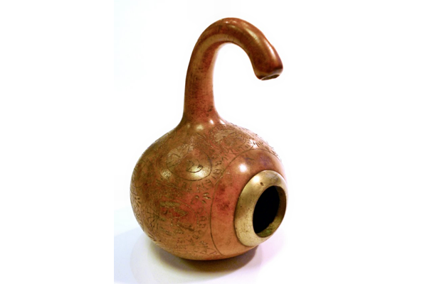 A 19th century gourd cup from Argentina decorated with various nationalist. It is fitted with a metal collar around the aperture and decorated with a series of individual cartouches enclosing symbols with the names of the Argentinian provinces inscribed above. - 1981.800 © McLean Museum and Art Gallery, Greenock.