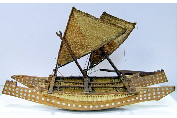 Model of a vaka or outrigger canoe with twin hulls, two sails, double ended, made of carved timber and extensively inlaid with mother-of-pearl discs. The central panelling is made from pandanus fibre. Made at Manihiki in the Cook Islands some time before 1876. - 2009.8 © McLean Museum and Art Gallery, Greenock.