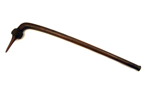 An early 19th century wooden war club from Fiji. The club is in dark wood with plain shaft and curved head in the form of a Pandanus fruit terminating in a point. The scholar of Fijian culture Fergus Clunie has said: "…the totokia was intended to "peck" holes in skulls." It "…delivered a deadly blow in an abrupt but vicious stab, not requiring the wide swinging arc demanded by the others".  - 1981.610 © McLean Museum and Art Gallery, Greenock.