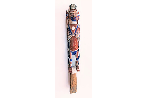 A late 19th century Malagan totem from New Ireland in the form of a carved figure in wood. The vertical figure carved from a single wooden post and is decorated in blue, white and brown pigment. - 1981.1434 © McLean Museum and Art Gallery, Greenock.