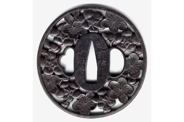 An eighteenth century Japanese swordguard or tsuba in an openwork design of cherry blossoms. Made by Saku Kinai of Echizen - 1981.54 - © McLean Museum and Art Gallery, Greenock