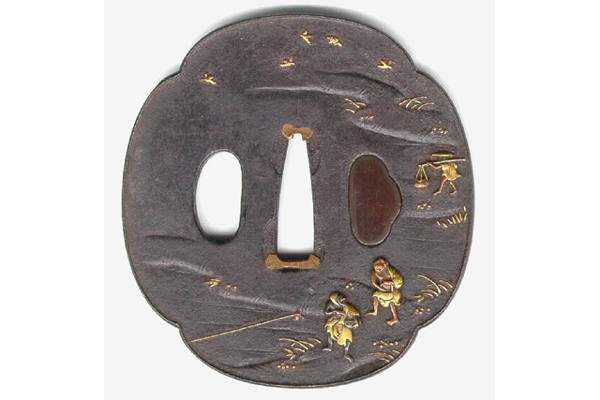 A eighteenth century Japanese swordguard or tsuba. The design shows a landscape with two men, in shakudo and gold, sowing rice, one in the distance with pannier and yoke. - 1981.71 - © McLean Museum and Art Gallery, Greenock