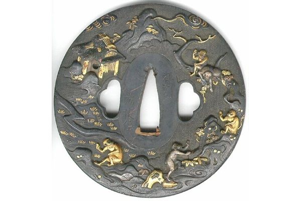 A eighteenth century Japanese swordguard or tsuba. The design shows a legendary subject featuring a dragon and a waterfall. The reverse shows numerous monkeys on rocks and trees and a hut. Signed by Nomura Hokio of Hikone - 1981.104 - © McLean Museum and Art Gallery, Greenock