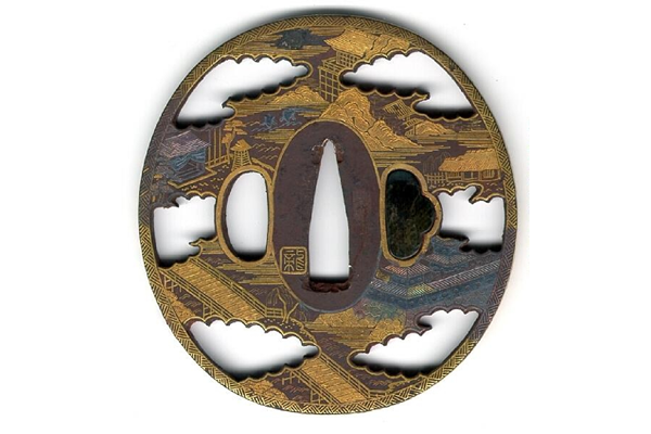 A late nineteenth century Japanese swordguard or tsuba. The open work design shows a landscape with castle, pagodas, bridge etc. with much gilding and several inlays. - 1981.108 - © McLean Museum and Art Gallery, Greenock