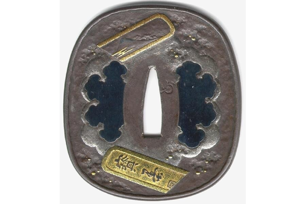 A Japanese swordguard or tsuba, date unknown. The design shows broken ink cakes on both sides. this face shows the cakes decorated with Mount Fuji and bearing an inscription. - 1981.155 - © McLean Museum and Art Gallery, Greenock