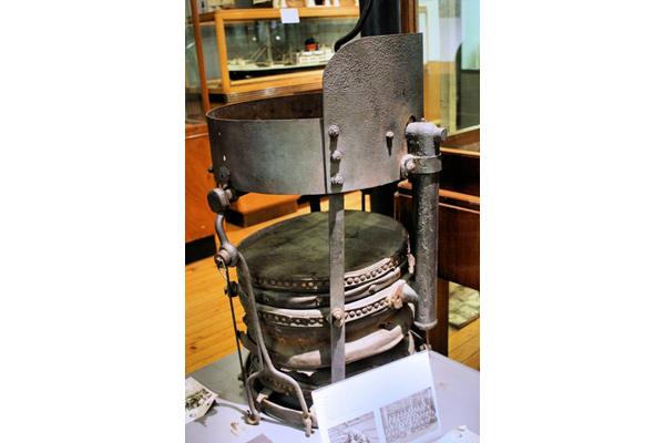 The pan was used to heat rivets in the Cartsburn yard of Scotts' Shipbuilding and Engineering Co. Ltd. The pan was attended by a boy, part of a team consisting of boy, a 'hodder on' who held the rivet in place and a riveter who used a hammer or a pneumatic gun. - 1978.675 - © McLean Museum and Art Gallery, Greenock