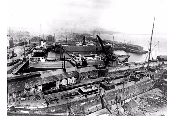 The sailing vessel Hougomont in the dry dock of Scotts' Shipbuilding and Engineering Co. Ltd., Greenock in 1897 with a view beyond over Victoria Harbour towards Greenock Town Centre in 1897. - WL3516 - © McLean Museum and Art Gallery, Greenock