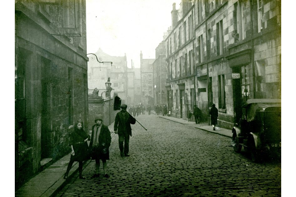 Chapel Lane, Port Glasgow with crowds on foot and a motor car. - 2009.98.13 - © McLean Museum and Art Gallery, Greenock.