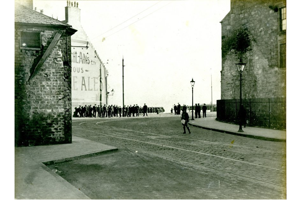 Crowds of men gathered at the corner of Scarlow Street and Fore Street, Port Glasgow. - 2009.98.17 - © McLean Museum and Art Gallery, Greenock