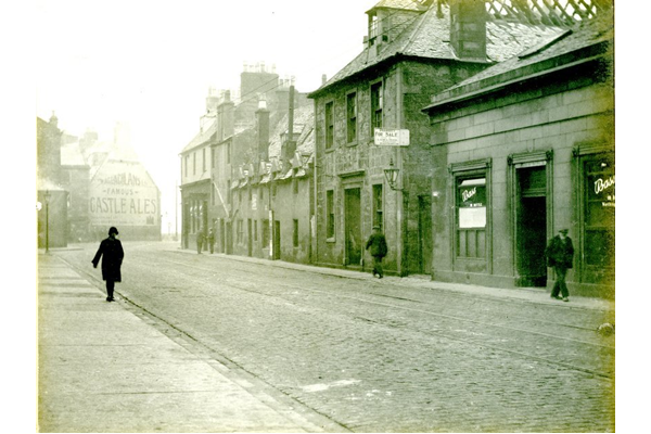 Shops and pub at Scarlow Street, Port Glasgow with tram lines visible. - 2009.98.41 - © McLean Museum and Art Gallery, Greenock