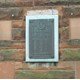 The memorial, known locally as 'The Toll Boys Memorial' is in the form of a wall plaque located at No. 5 Robert Street, Port Glasgow.