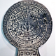 A black glazed flat ceramic zodiac disc from Mexico, period unknown, decorated with twenty signs in outer circle and four in the centre. - 1981.860 © McLean Museum and Art Gallery, Greenock.