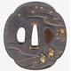 A eighteenth century Japanese swordguard or tsuba. The design shows a landscape with two men, in shakudo and gold, sowing rice, one in the distance with pannier and yoke. - 1981.71 - © McLean Museum and Art Gallery, Greenock