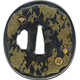 A Japanese swordguard or tsuba, date unknown. The design shows a gilded saya pattern with mons and swastikas including flowers and the Kiri mon and leaves. - 1981.80 - © McLean Museum and Art Gallery, Greenock