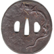 A seventeenth century Japanese swordguard or tsuba. The design has a hammered surface with a rain dragon carved in relief with gilding. - 1981.91 - © McLean Museum and Art Gallery, Greenock