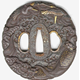 A Japanese swordguard or tsuba, date unknown. The design shows a central area of turbulent waves with storks and the giant hairy tailed tortoise on the rim. - 1981.107 - © McLean Museum and Art Gallery, Greenock