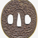 A Japanese swordguard or tsuba, date unknown. On both faces there is a floral design. One face shows an animal, possibly a dragon, and a fox. The edge of the tsuba is gilded. - 1981.158 - © McLean Museum and Art Gallery, Greenock